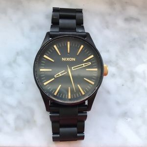 Nikon black and gold watch